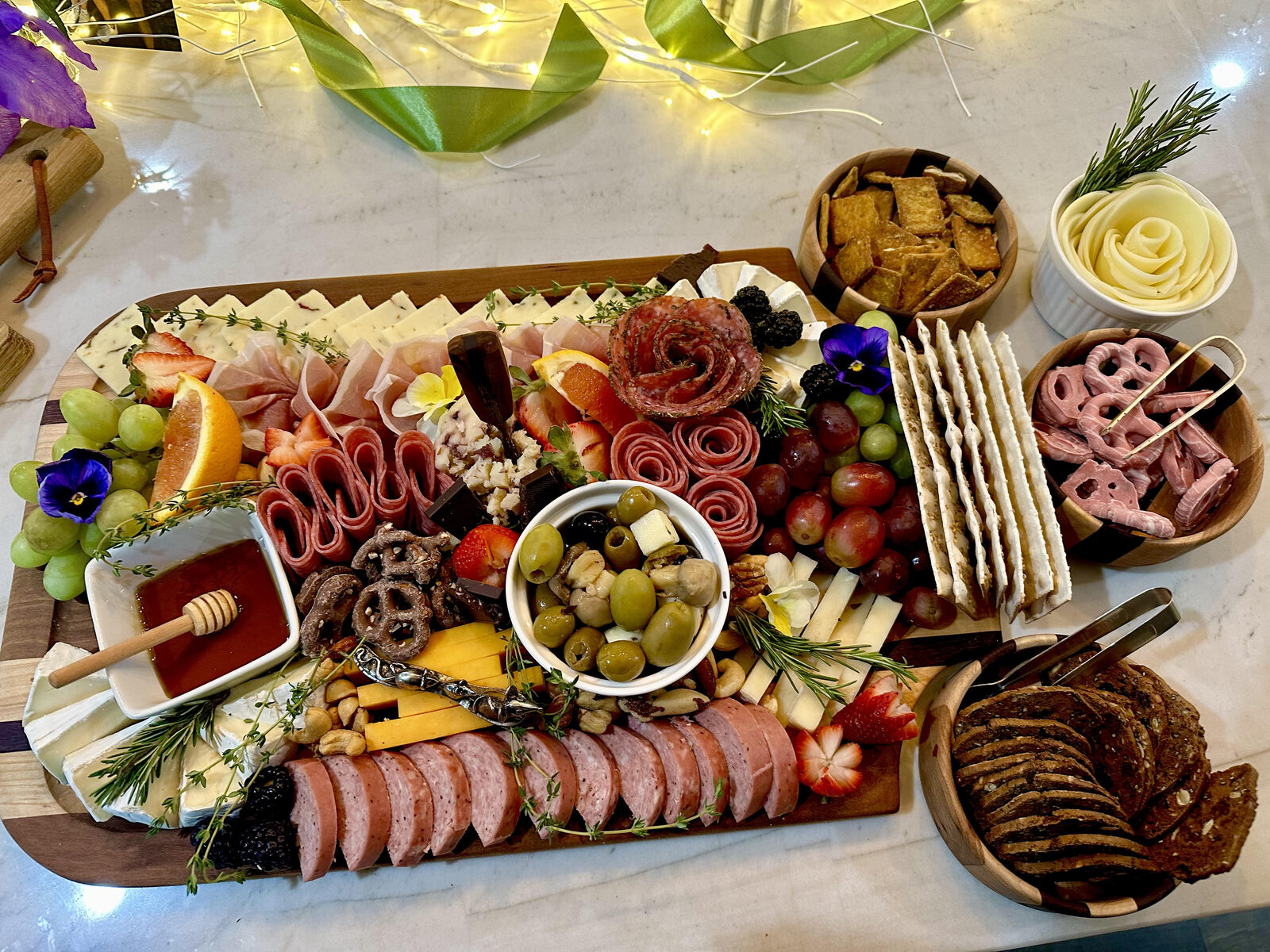 Long grazing board on marble with dips and crackers