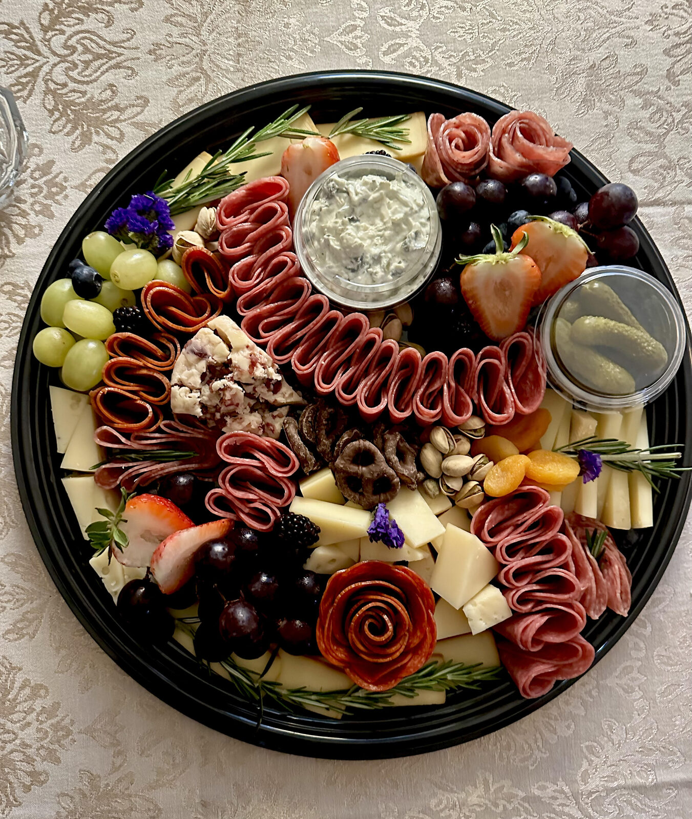 Round platter with salami-ribbon spiral and dip