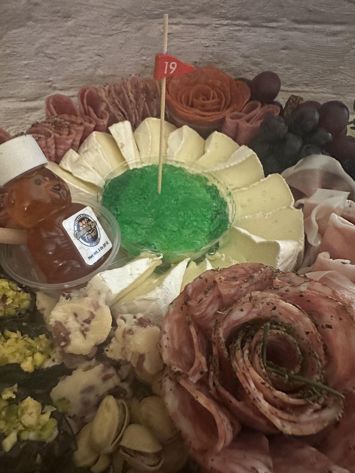 Themed charcuterie board detail with salami roses